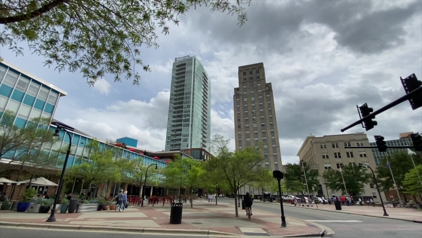 Two tall buildings overlook Durham, North Carolina as cars drive by.