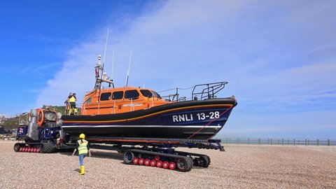 Hastings, East Sussex, UK, April 13, 2022. The RNLI Shannon Class Lifeboat towed by the launch and recovery system towards the Lifeboat station at Hastings.