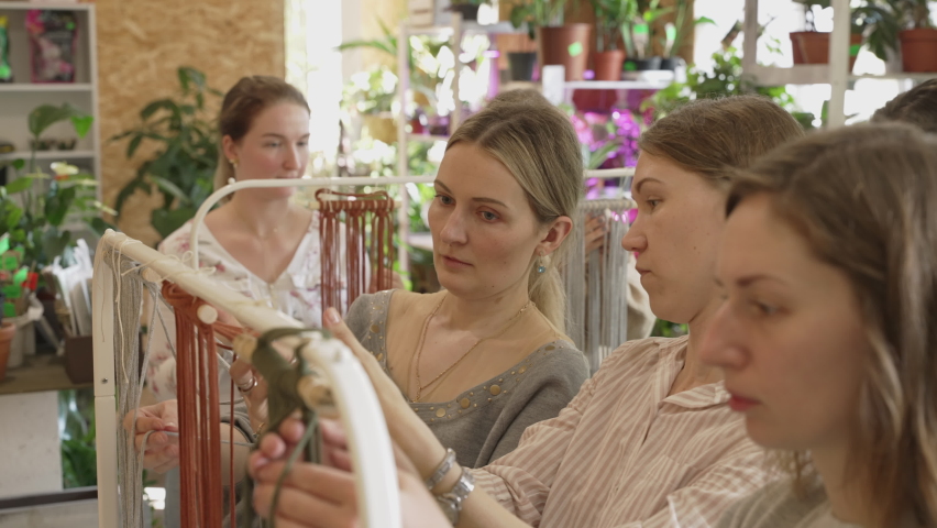 Group of women attending art class. Female students and teacher makes home decor in Boho style in workshop together. Weaves handmade macrame at art school studio. Creativity, people education | Shutterstock HD Video #1089655767
