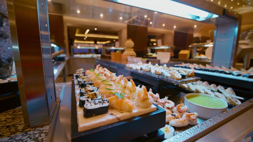 Japanese food self-service luxury hotel in Tunisia. All-you-can-eat buffet during lunch, dinner time. Resort restaurant. All inclusive. Buffet food. Self-service restaurant. Self service meals. Cateri Royalty-Free Stock Footage #1089658543