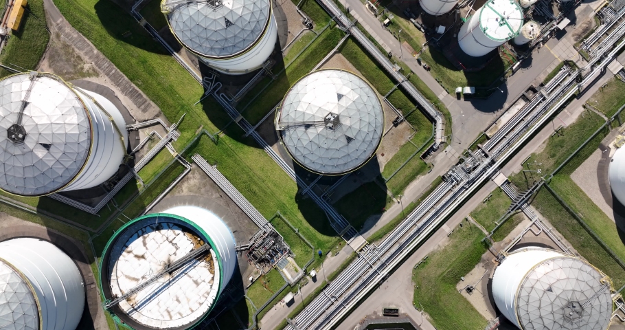 Large chemical oil silos. Heavy large industrial dock in Rotterdam. The Netherlands. Petrochemical storage energy containers. Top down aerial view. | Shutterstock HD Video #1089658941