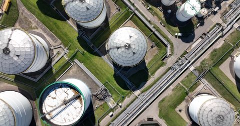 Large chemical oil silos. Heavy large industrial dock in Rotterdam. The Netherlands. Petrochemical storage energy containers. Top down aerial view.