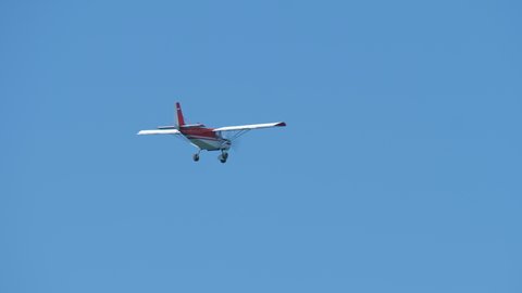 Airplane flies in blue sky. Fixed wing aircraft with rotating airscrew in front moving in heavens. Small propeller-driven plane. Bottom view. Safe transportation, logistics. Aviation, insurance