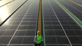 African man engineer using digital tablet maintaining solar cell panels on building rooftop. Technician working outdoor on ecological solar farm construction. Renewable clean energy technology concept - Powered by Shutterstock - Get 15% off with code: PIKWIZARD15