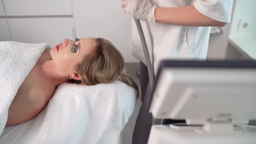 Cosmetic facial rejuvenation procedure. Facial treatment of a beautiful young woman in a cosmetic beauty salon. Types of cosmetic procedures for the face. | Shutterstock HD Video #1089659883