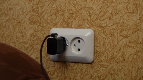 the charger for the phone is connected to the socket. 4k footage