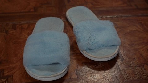 blue house slippers on linoleum. 4k frame