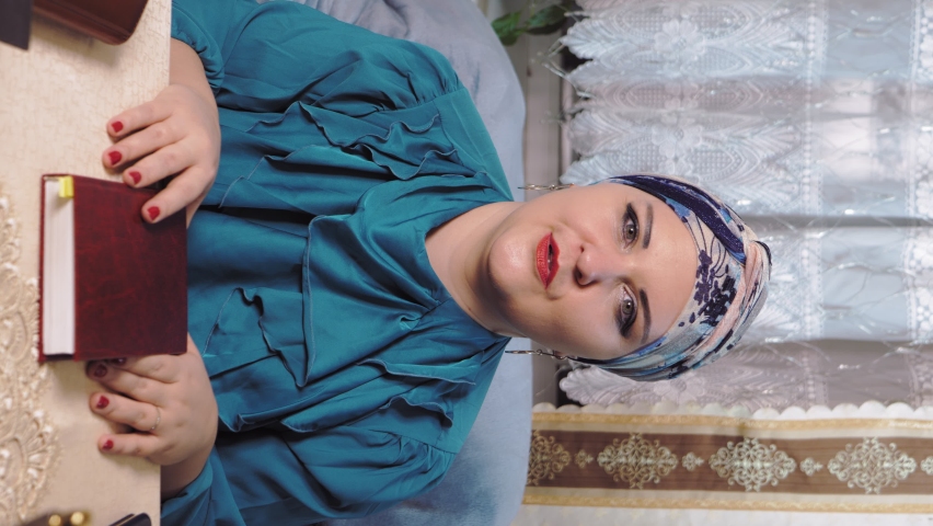 A female rabbi of a progressive Jewish community wearing a traditional headdress teaches a Torah lesson. Vertical video