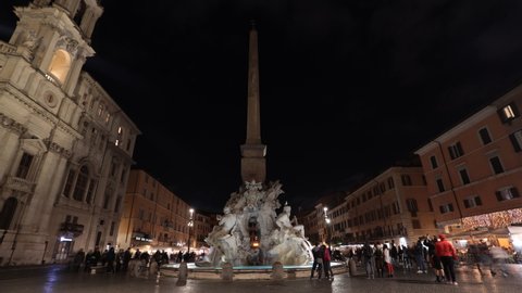 Rome, Italy - April 24, 2022: The beautiful Fountain of the Four Rivers in Piazza Navona in the historic center of Rome. Night time lapse.