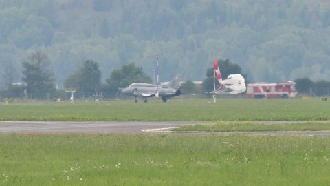 Zeltweg Austria SEPTEMBER, 6, 2019 Fighter plane releases the braking parachute on the airport runway after landing. Sukhoi Su-22 Fitter of Polish Air Force variable-sweep wing fighter-bomber jet