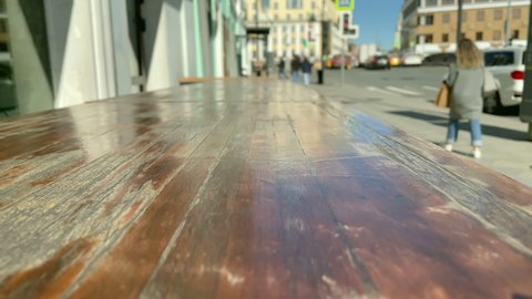 Outdoor cafe table. Long wooden table of an outdoor bar on the Pyatnitskaya street. Moscow city center. Hospitality industry.