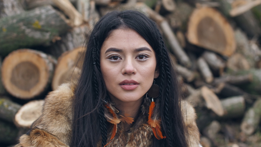 asian young woman covers her face with her hands with painted eyes on her palms.portrait of asian young mestizo woman