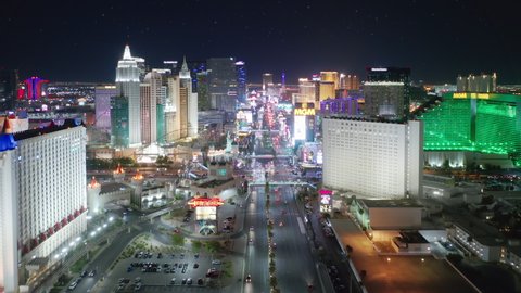 Las Vegas Strip, Nevada, Apr. 2022. Cinematic aerial neon city lights with Excalibur, New York and MGM Grand hotels view. Entertainment capital of the world with famous casinos and 5-stars resorts 4K