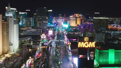Las Vegas Strip Nevada Apr. 2022. Entertainment gambling capital, holiday concept 4K. Cinematic close up aerial of above busy night traffic with scenic Aria Cosmopolitan resort at night illumination