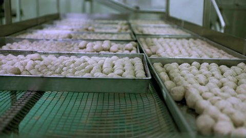 Produce meatballs on a large scale in a food factory.