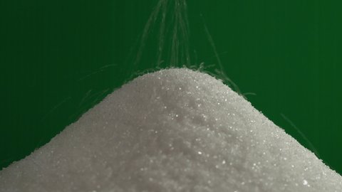 Pouring sugar on green screen background
