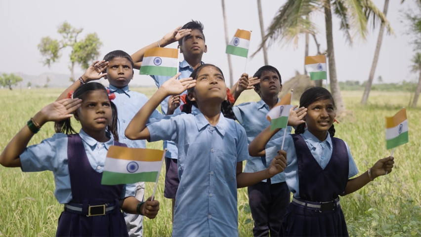 Group of village school children with Indian flag in hand saluting by looking above during flag hosting - concept of independence or republic day celebration Royalty-Free Stock Footage #1089682715