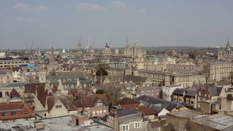 Drone shot past Christ Church Tom Tower towards Bodleian library Radcliffe camera Oxford