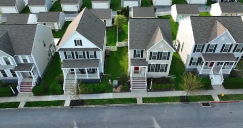 Similar new homes on suburban street. New modern architecture design for single family homes in USA. Aerial truck shot. Postage stamp size lots.