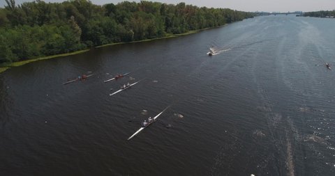 Drone shot for a rowing competition. Athletes in training, city rowing canal in the city of Kyiv. Ukraine. Groups of athletes are rowing rowing boats on the river.