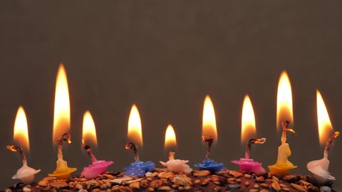 Burning candles in a birthday cake. Close up colorful flame candles in homemade cake.Birthday candles for home party