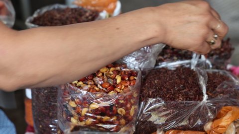 Woman Holding Fried Grasshoppers (chapulines)  in Mexican Market in Oaxaca