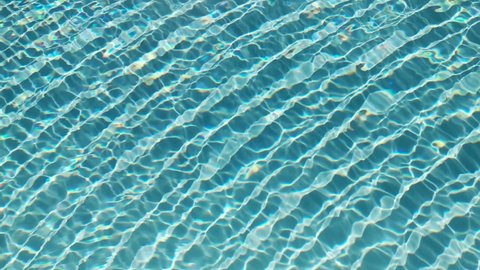 Water surface texture, Slow motion clean swimming pool ripples and wave, Refraction of sunlight top view texture sea side white sand, sun shine water background. Water Caustic Background