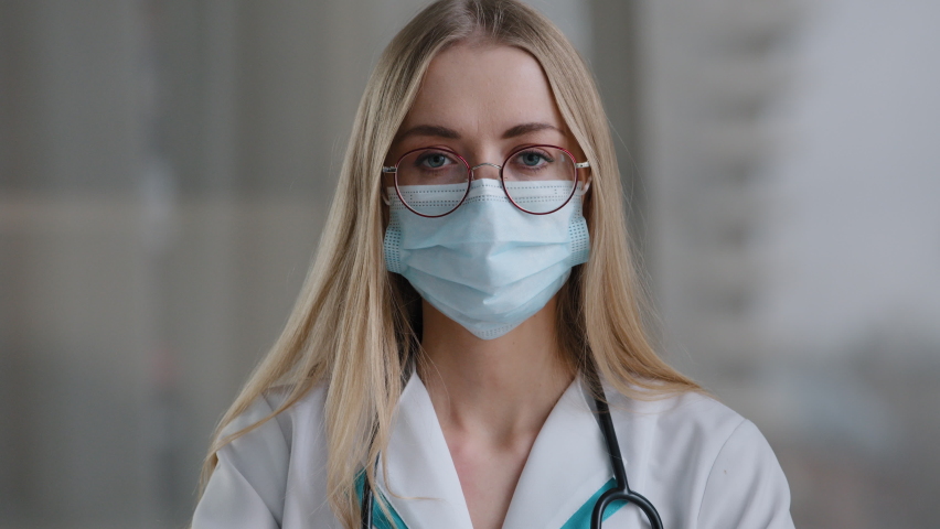 Female doctor in medical mask looking at camera talking angry show index finger no negative gesture mad stressed woman psychologist nurse in white coat office show one with hand aggressive explain Royalty-Free Stock Footage #1089696903