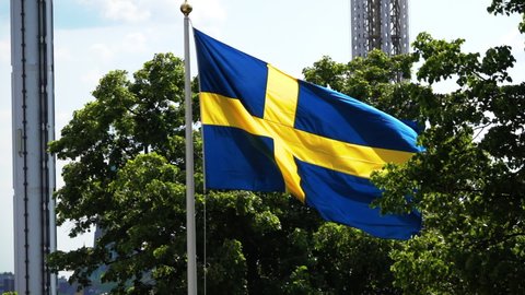 Lockdown Slow Motion Shot Of Sweden Flag Waving On Pole In Sunlight - Stockholm, Sweden