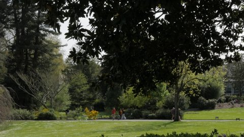 Nantes, France - April 10, 2022: People walking in a botanical garden park Jardin des Plantes