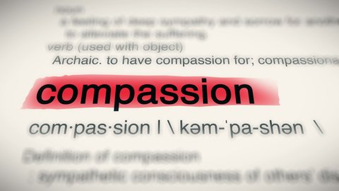 Sukabumi, Indonesia, April 25 2022: The Word Compassion Red Highlighted in a Dictionary Animation