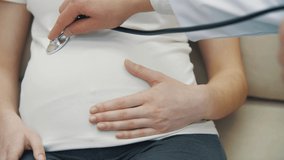 4k slow motion close up video of doctor examining pregnant woman with a stethoscope. - Powered by Shutterstock - Get 15% off with code: PIKWIZARD15