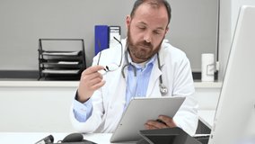Thoughtful male doctor using digital tablet thinking of medical problem solution. High quality 4k footage