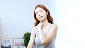 Young asian women doing herself a neck and shoulder massage to protect office syndrome
self massage concept.
