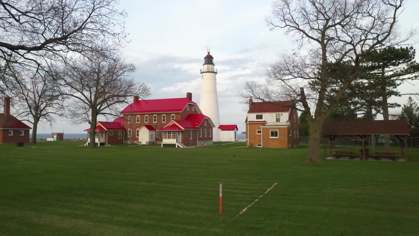 Fort Gratiot Lighthouse in Port Huron, Michigan with drone video moving forward from low ground.