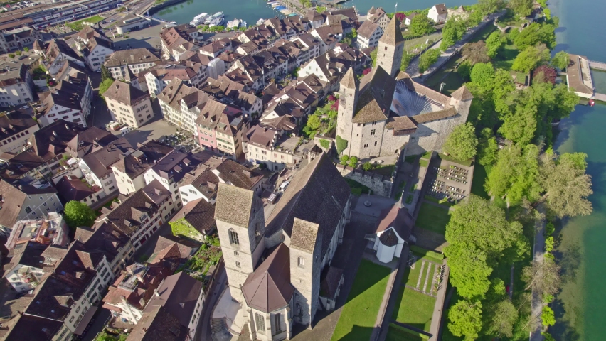 Aerial view of medieval castle, church and old town at Swiss City of Rapperswil-Jona, Canton St. Gallen, with Lake Zürich in the background. Movie shot April 28th, 2022, Rapperswil-Jona, Switzerland.