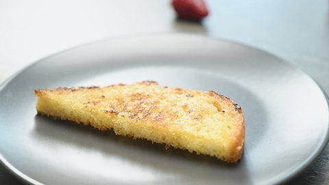 The cook serves French toast in a plate.