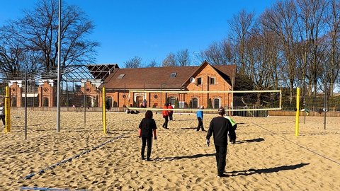 Kaliningrad, Russia, 12, March, 2022:
Elderly Europeans play volleyball with the arrival of heat, elderly people play volleyball on the beach