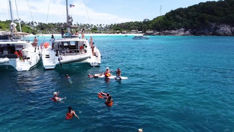 Phuket, Thailand, 19, December, 2020:
Tourists swim in the warm tropical sea off the coast of a tropical island, during a boat trip on sailing catamarans