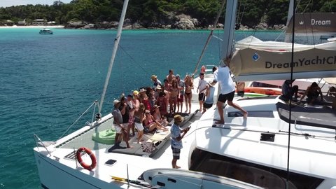 Phuket, Thailand, 19, December, 2020:
A large international company has a rest on sailing catamarans, a sea trip on sailboats to tropical islands, a group photo together
