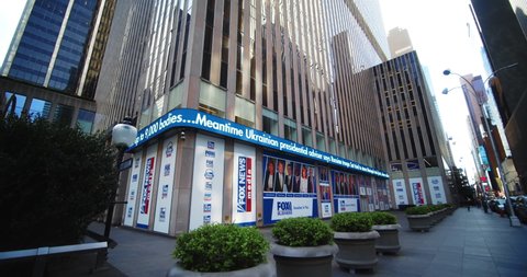 New York, New York United States - April 23,  2022: Pan down of Fox News Corporation Headquarters to news ticker in Fox Square on 6th ave in manhattan.