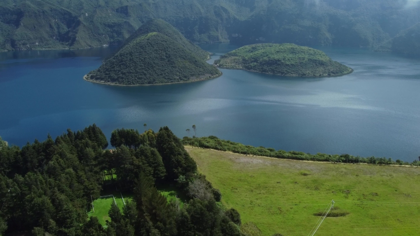 Laguna Cuicocha, Ecuador: Aerial drone footage with tilt up motion of the Laguna Cuicocha at the foot of the Cotacachi volcano near Otavalo in the Andes mountains in Ecuador in south America  Royalty-Free Stock Footage #1089719859