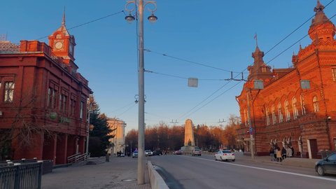 Bolshaya Moskovskaya Street, Vladimir city, 04.2022. Traffic on the street, the street is visible in the middle, red brick houses with turrets on the sides. High quality 4k footage