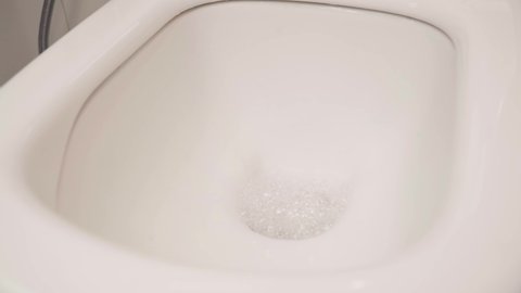 Flushing water in toilet after disinfection. toilet disinfection.