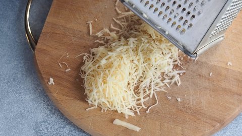 Soft cheese tinder on a kitchen grater into small pieces