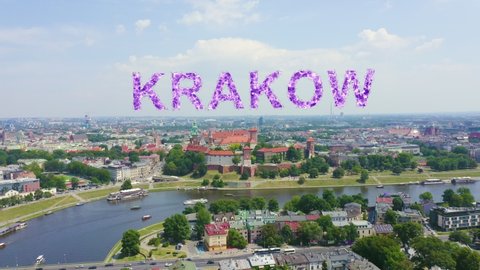 Inscription on video. Krakow, Poland. Wawel Castle. Ships on the Vistula River. View of the historic center. Shimmers in colors purple, Aerial View