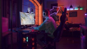 Zoom In Close Up of an eSports Gamer Plays RPG Strategy Video Game with Lots of Action and Fun on His Powerful Personal Computer at Home in Loft Apartment. Successful Man Wins the Tournament.