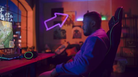 Gaming at Home: Gamer Putting on Headphones and Playing Online Video Game on Computer. Stylish Black Male Player Enjoying RPG Strategy Arcade Online Multiplayer PvP Tournament.