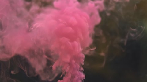 View of pink smoke on a black background.