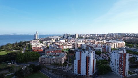 DRONE PAN AERIAL FOOTAGE: The Vasco da Gama Bridge and the Vasco da Gama Tower at Park of Nations in Lisbon. Modern residential neighborhood with contemporary architecture.